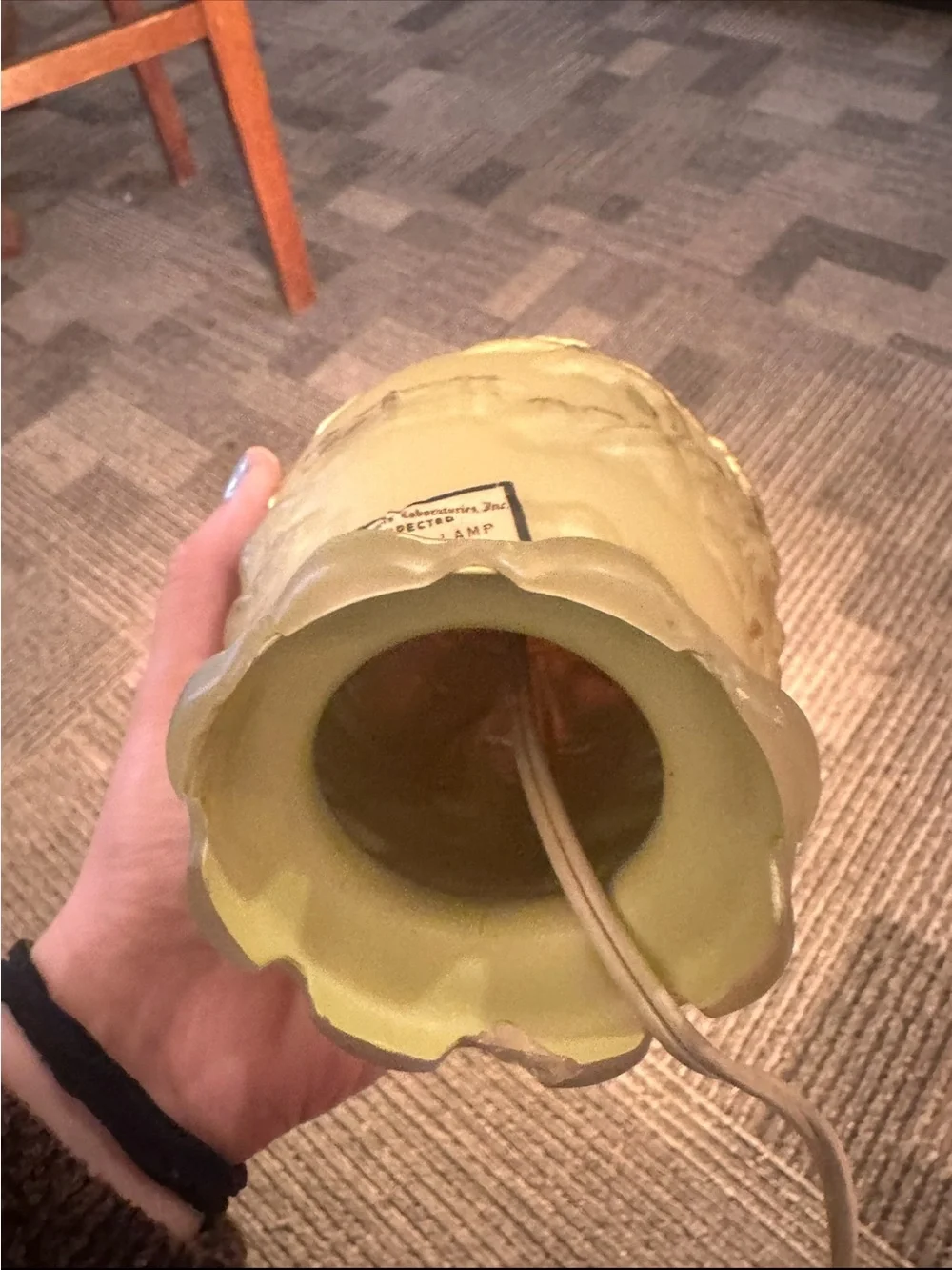 Vintage yellow molded glass table lamp features an embossed Asian landscape